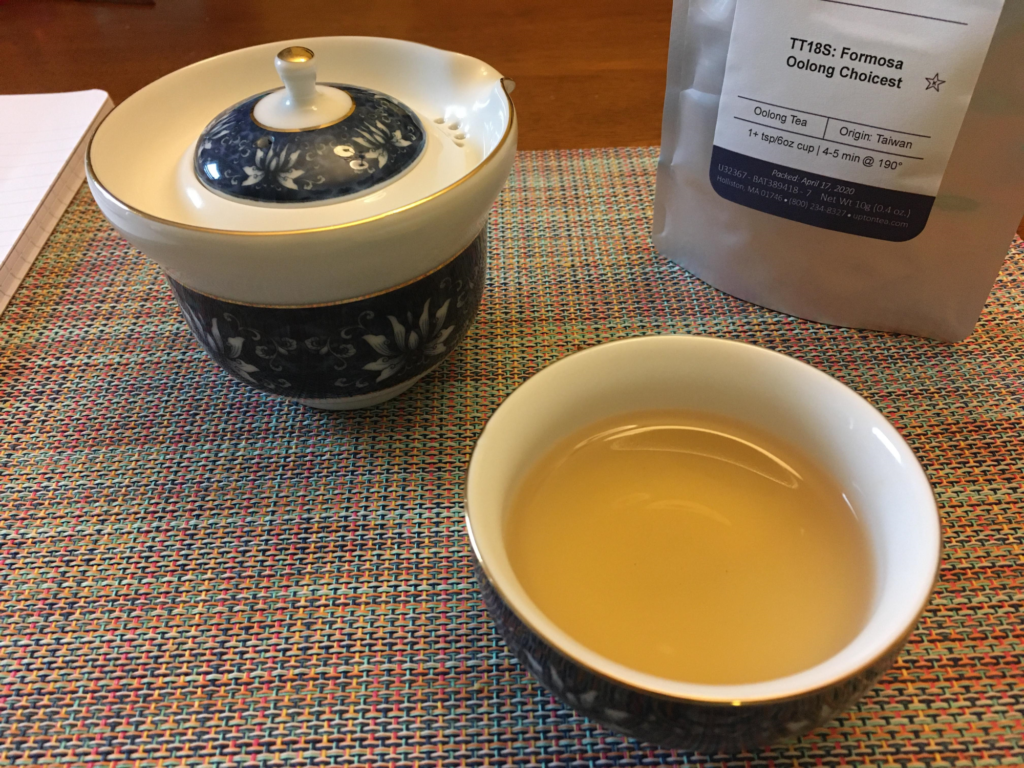 Cup of oolong tea with teapot and Formosa Oolong Choicest packet in the background