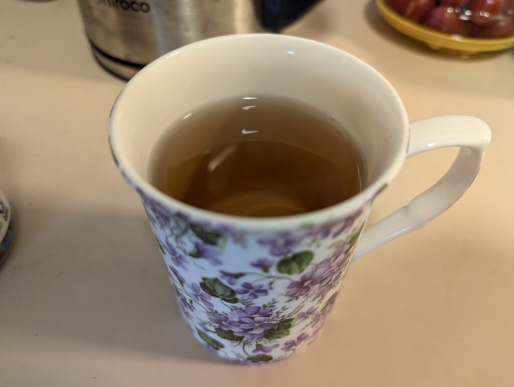 Amber-colored Kukicha tea in a mug.